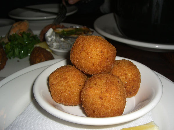 Golden fried cheese croquettes in a small bowl