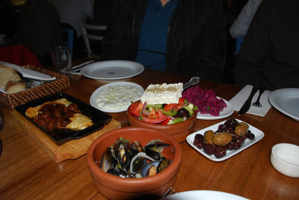 Greek meze spread with saganaki, tzatziki, horiatiki salad, mussels and olives