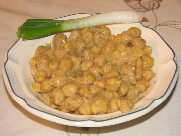 Bowl of Greek stewed chickpeas with a spring onion