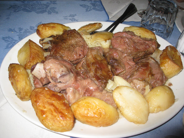 Portion of kleftiko, slow-cooked lamb with roast potatoes
