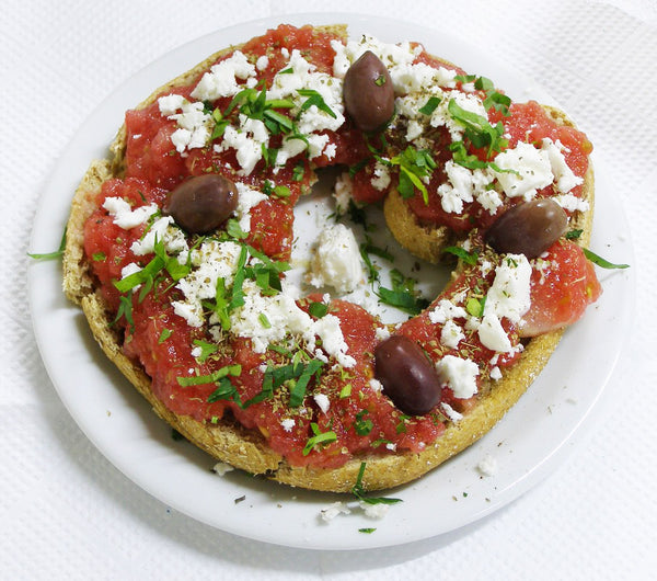 Dakos: barley rusk topped with tomato, feta and olives