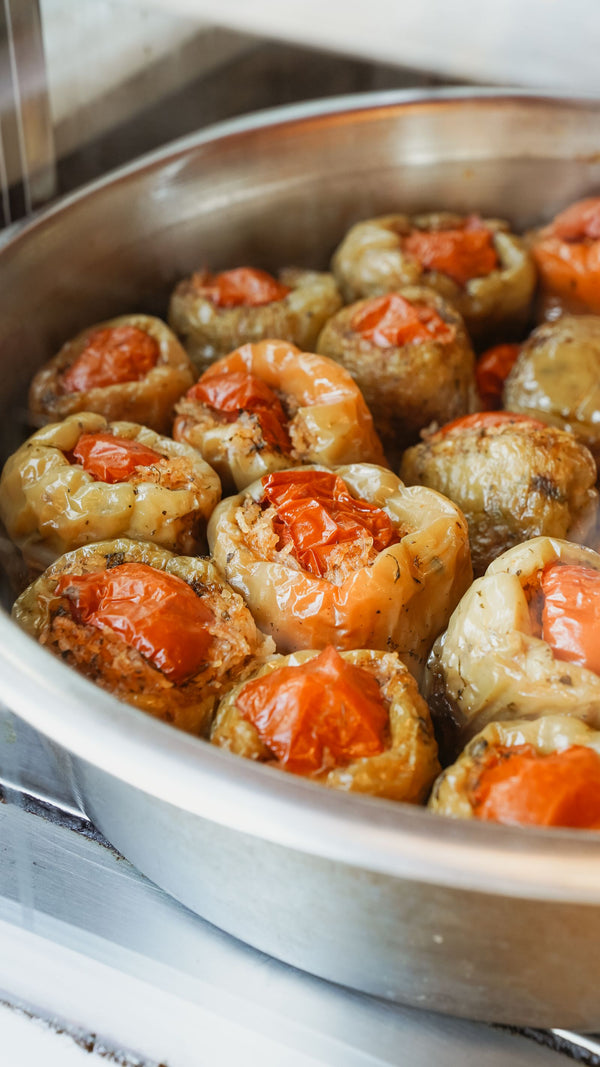 Stuffed peppers with tomatoes in a metal pan